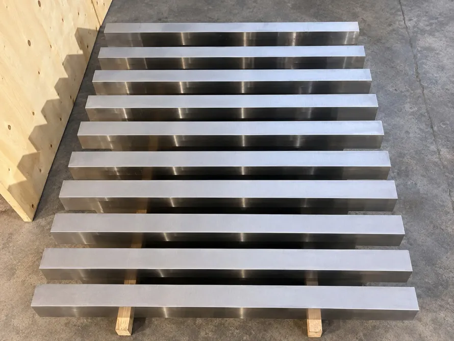 Rectangular metal bar stock arranged on wooden supports