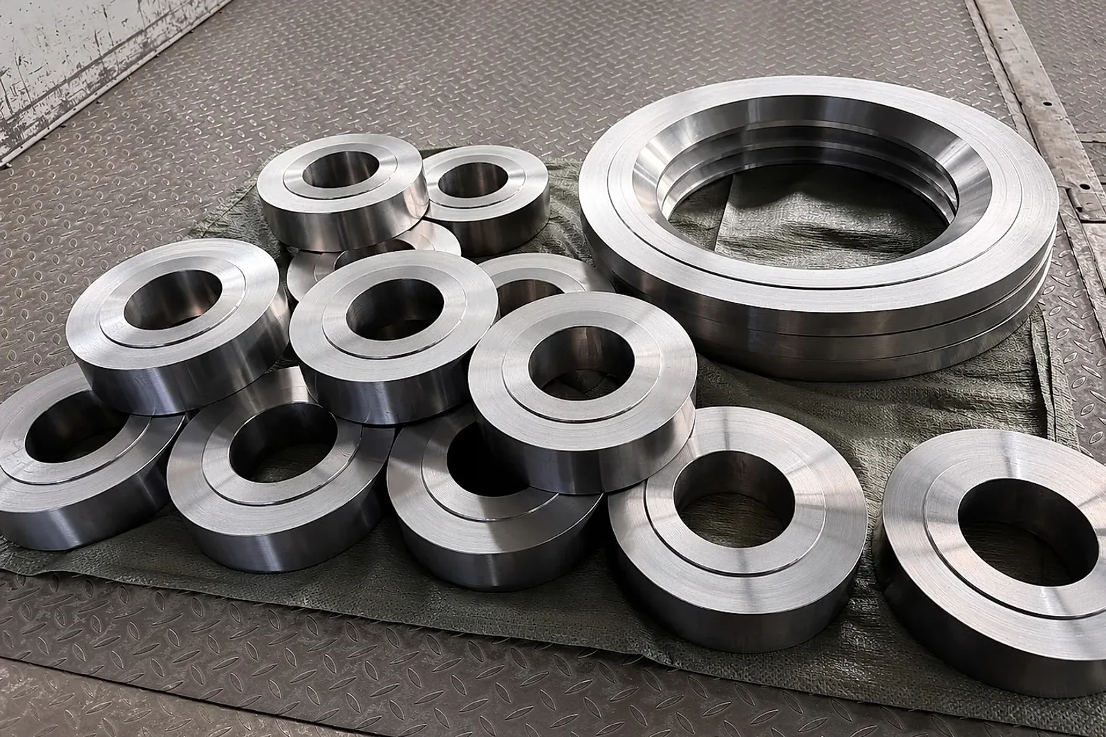 Machined titanium ring blanks grouped for shipment, illustrating why source control has to travel from strategic supplier decisions into lot-level release records.
