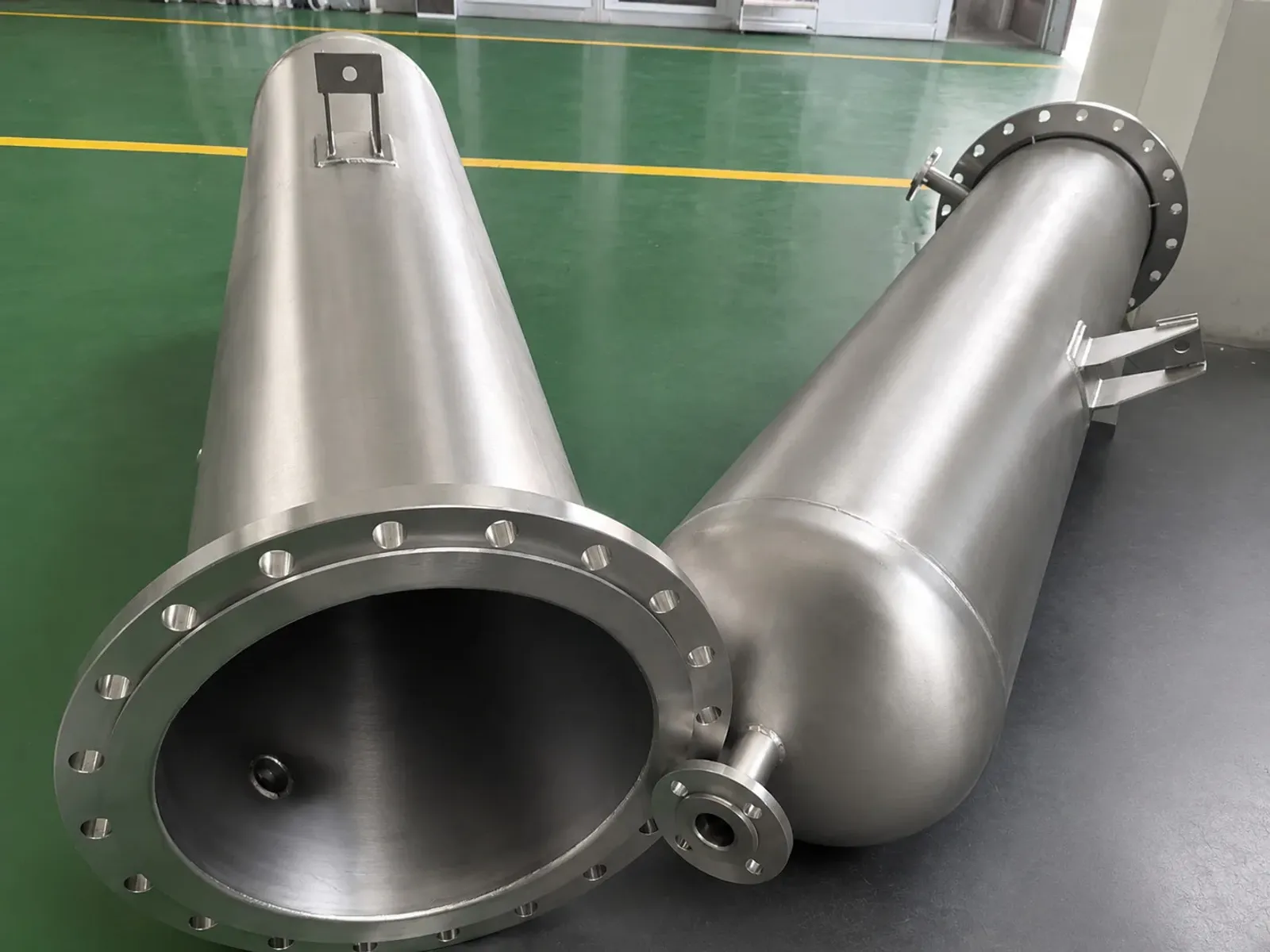 Cylindrical titanium shell components with flanged openings