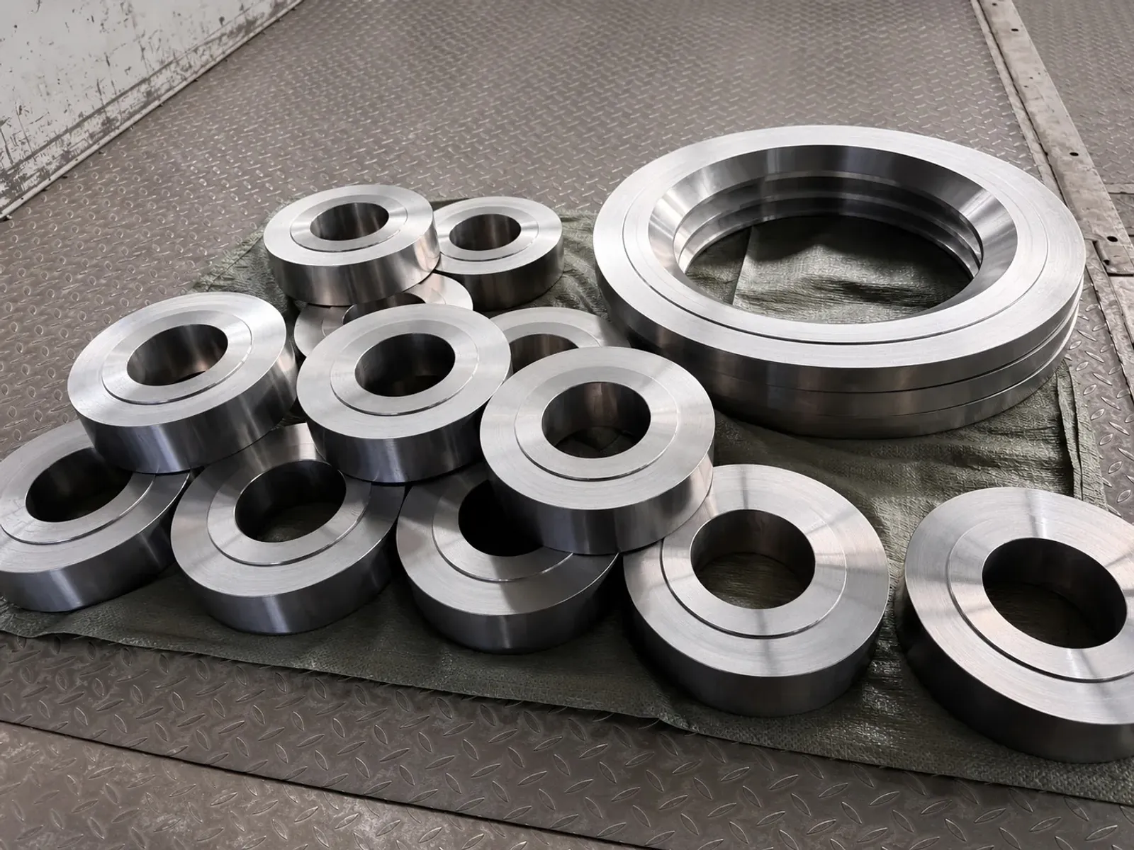 User-supplied machined titanium ring blanks represent released component geometry; they are not PBF specimens or fatigue-test evidence.