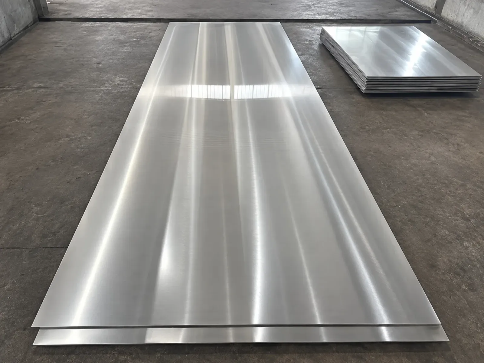 Large brushed metal sheet in a workshop inspection area