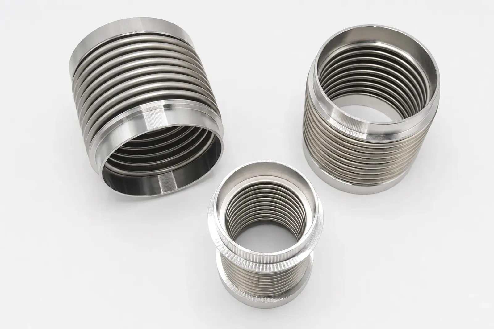 User-supplied titanium bellows products show thin-wall geometry and finished surfaces; they are not TiAl parts or repaired study specimens.