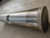 Large cylindrical metal billet with smooth bands and a rough cut end