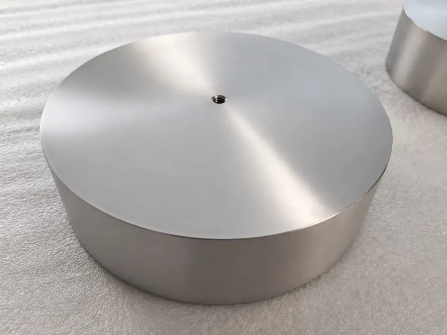User-owned finished titanium disc used to illustrate a controlled surface; it is not a specimen from the reported laser study