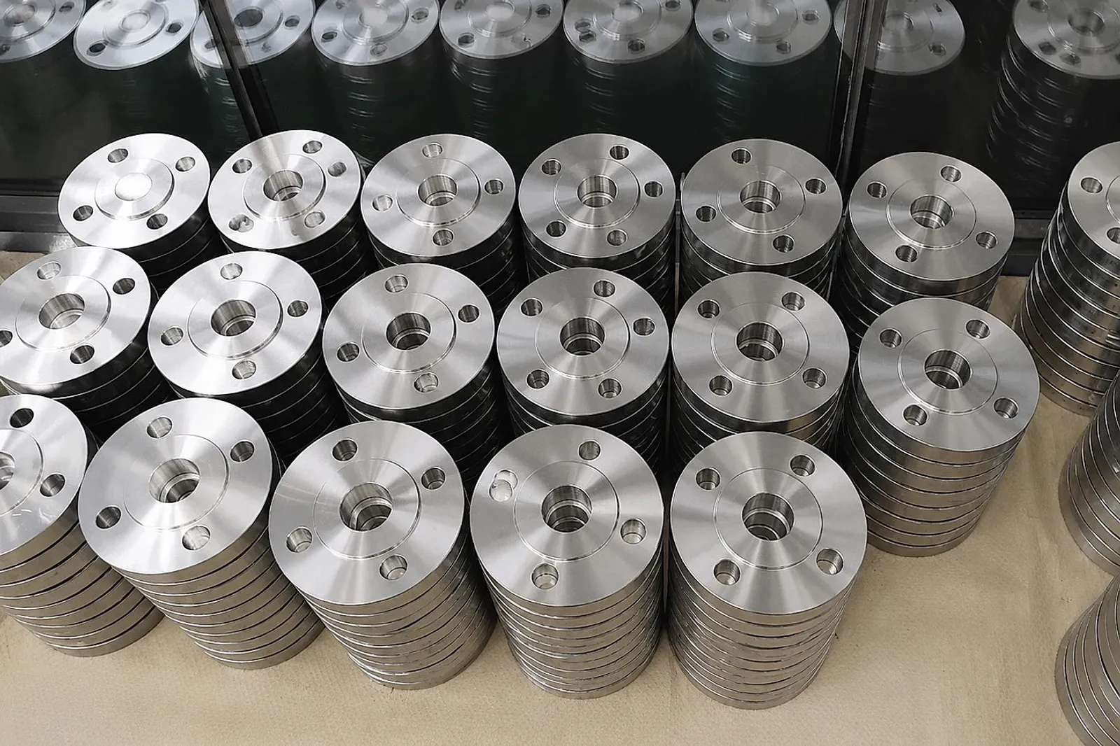 Machined titanium parts and stock material arranged for buyer release planning, illustrating why digital spare-part files still need material and inspection evidence.