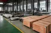 Titanium stock, round material and export crates in a factory warehouse, showing why a sponge-price signal still needs product-form, conversion and release evidence
