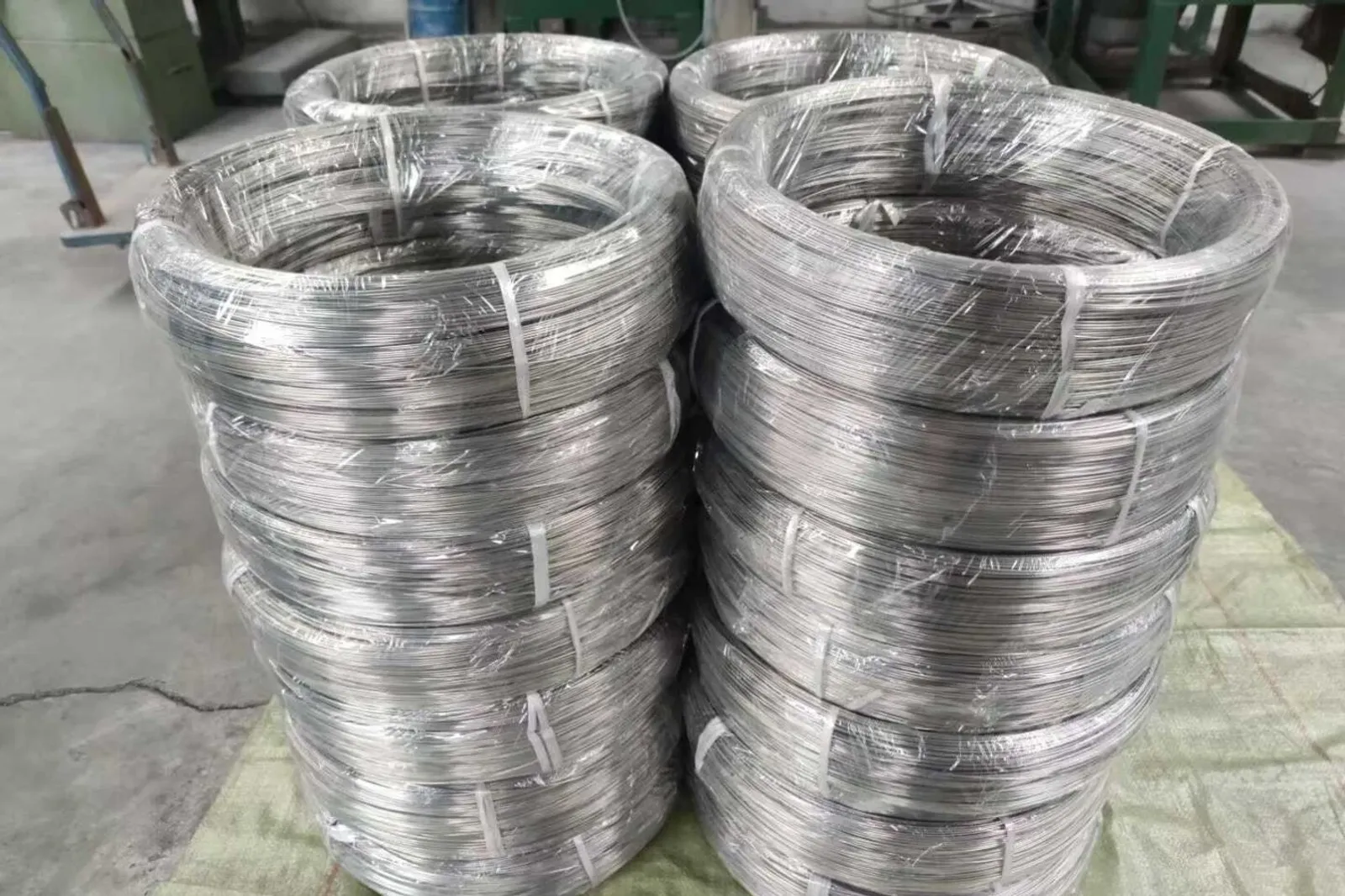 Titanium wire coils prepared for controlled feedstock handling, a reminder that wire-fed routes depend on batch identity, surface condition, storage and traceability before deposition begins.