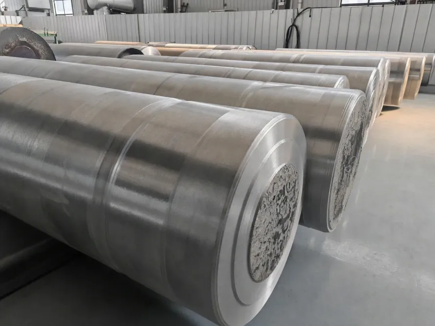 Rows of large cylindrical metal billets in a workshop