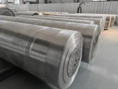 Rows of large cylindrical metal billets in a workshop