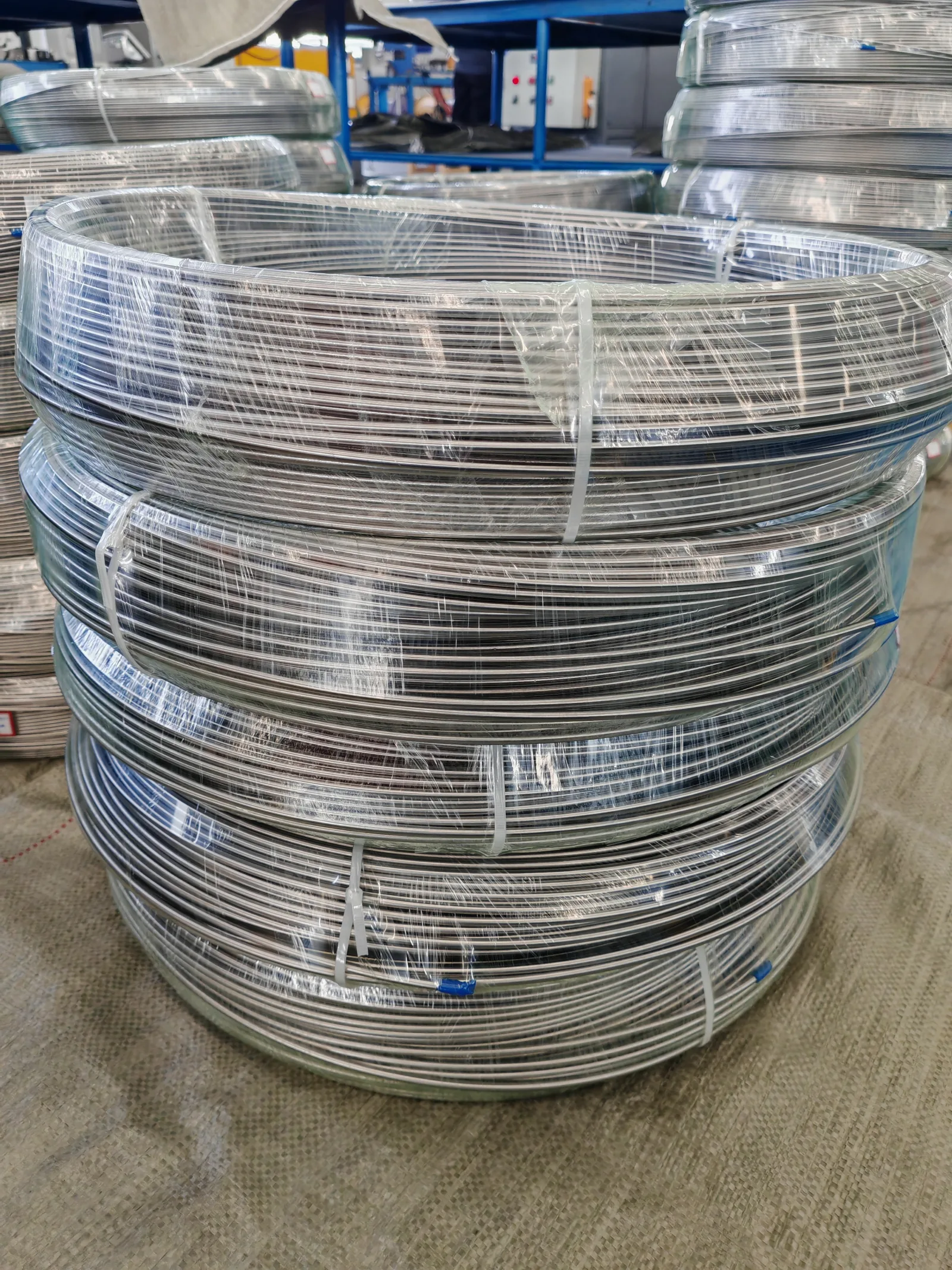User-supplied coiled titanium stock illustrates how product geometry and handling state change the transfer boundary for a surface-finishing process.