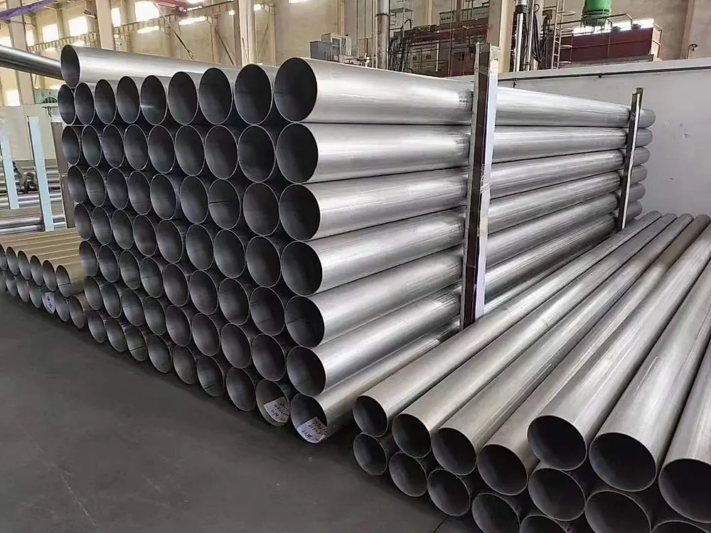 Large-diameter titanium tubes stacked in factory workshop