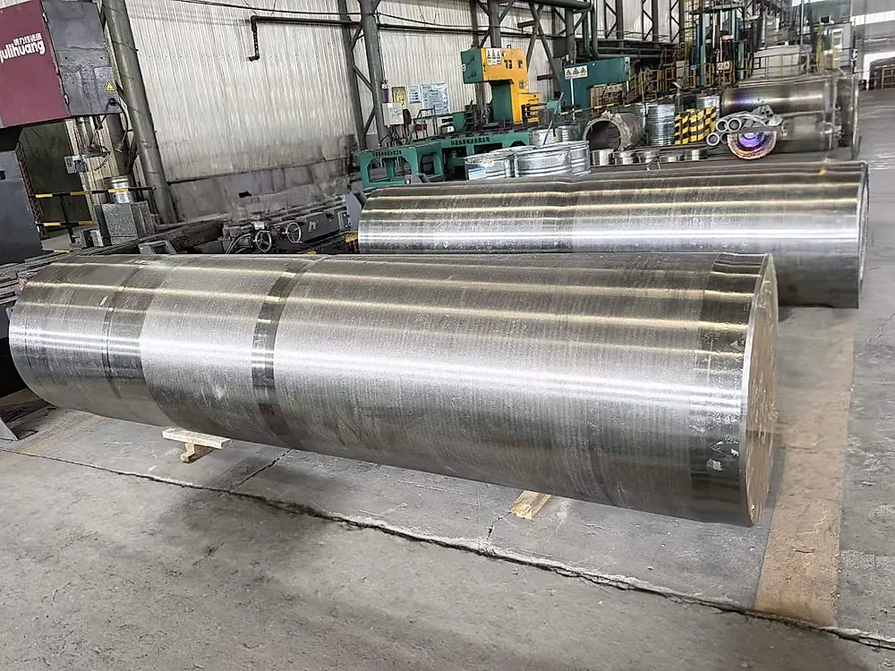 Large titanium billet and forged rod on shop floor — aerospace flight-critical feedstock