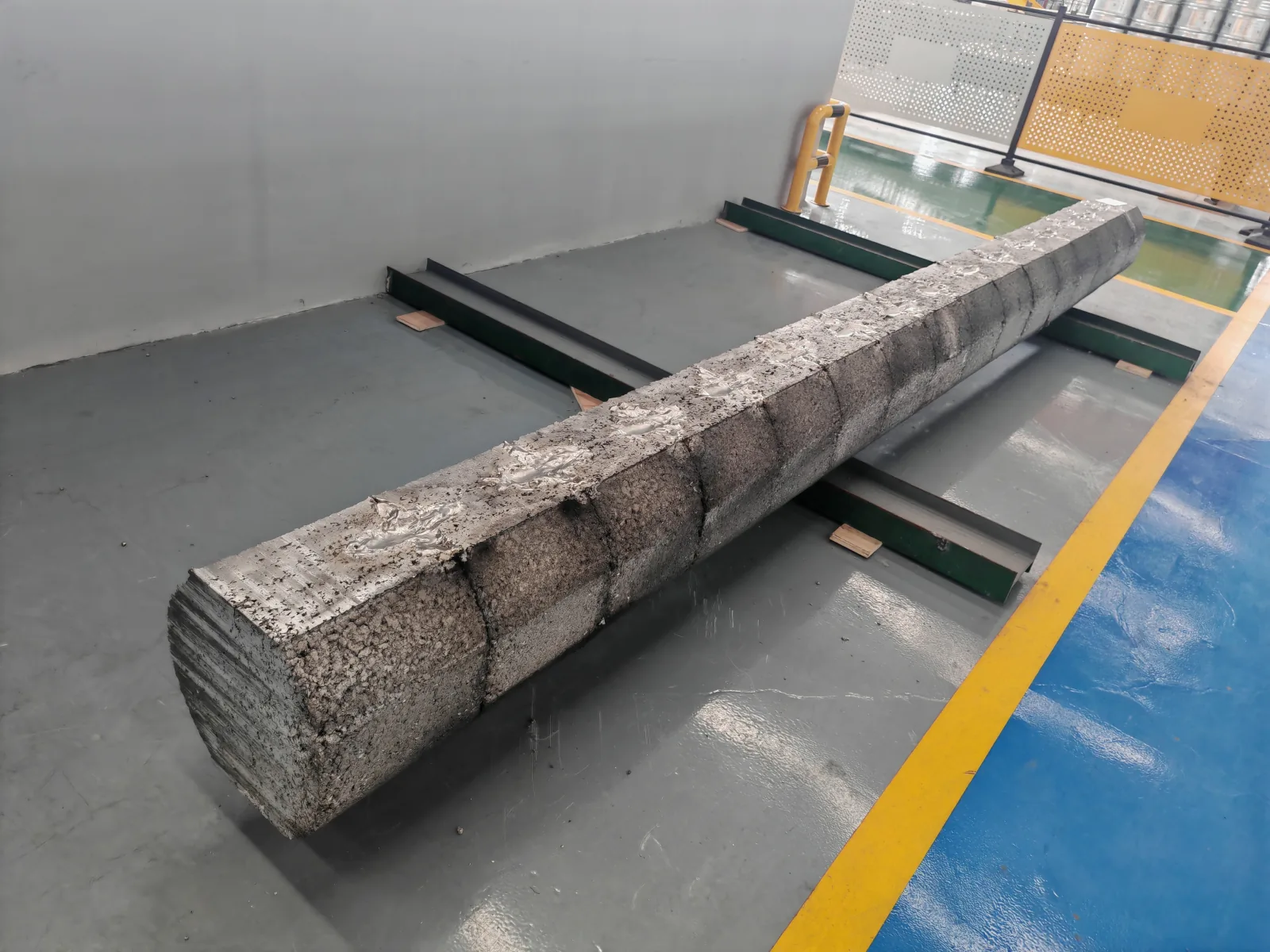 User-supplied rough titanium stock illustrates an earlier material state whose processing history cannot be inferred from the final treatment label alone.