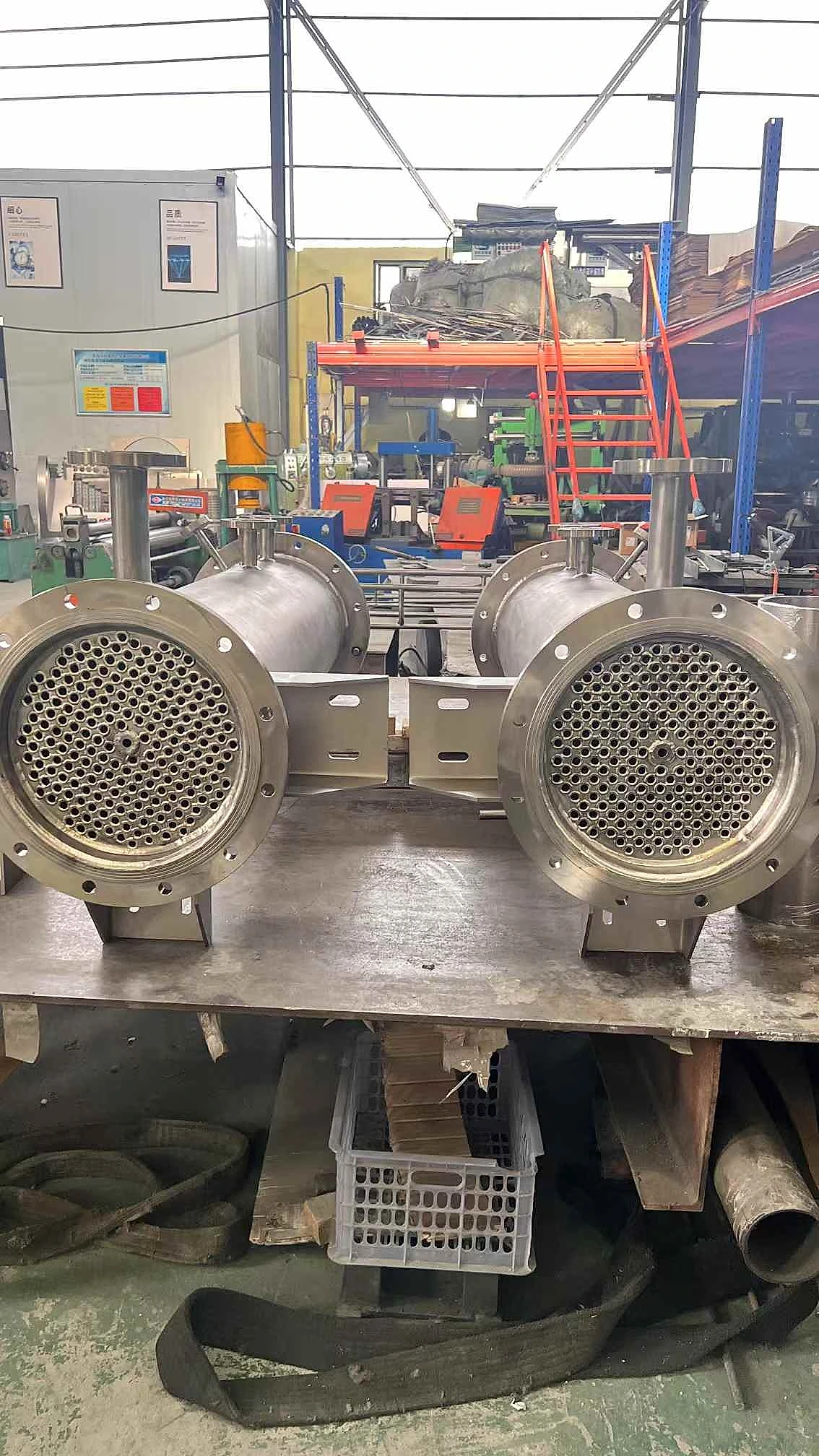 Titanium tube bundle heat exchangers with tubesheet visible in factory