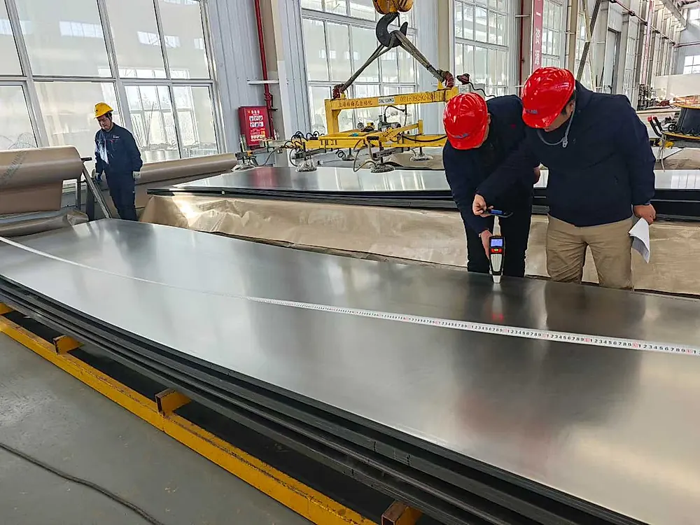Quality inspector measuring titanium sheet dimensions with tape measure