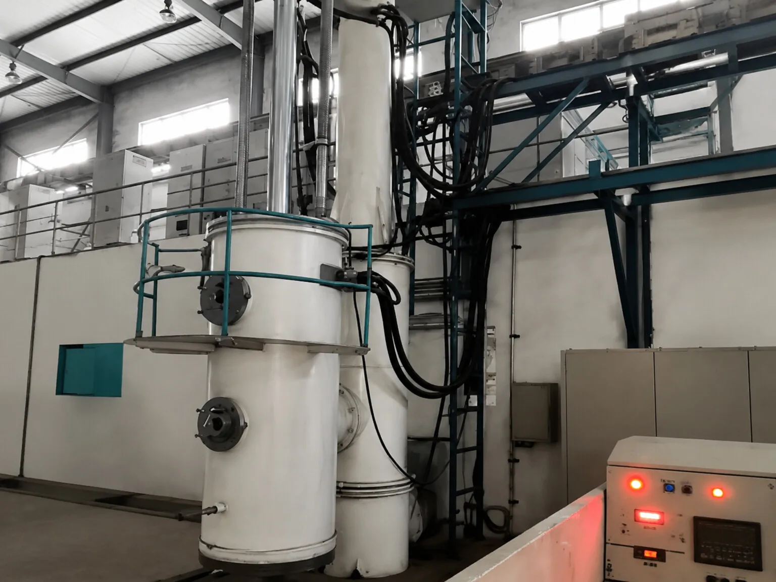 Enclosed industrial thermal-processing equipment in a workshop