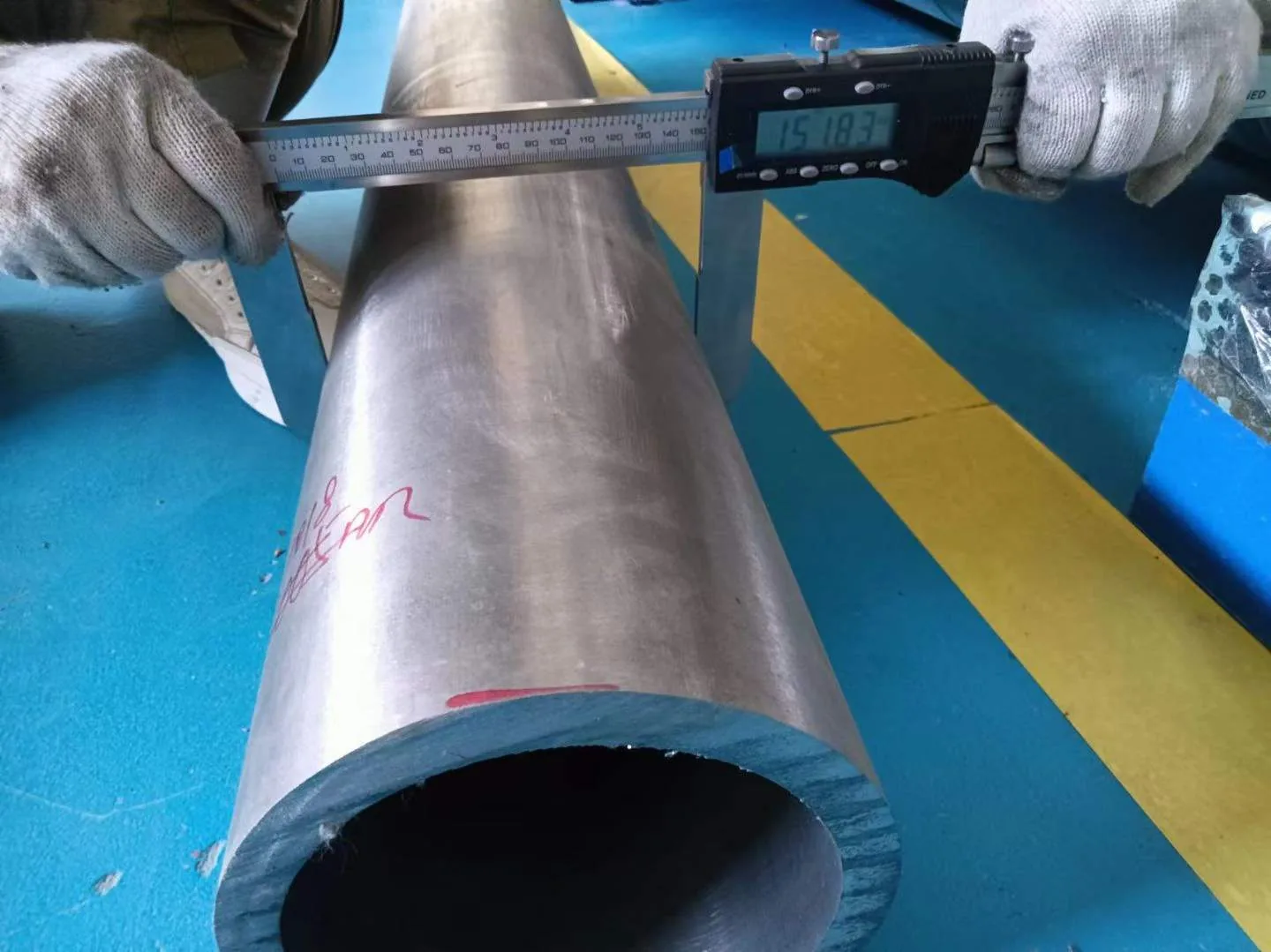 User-supplied dimensional inspection of a titanium tube illustrates why the build history must remain linked to final-part verification; it is not the study setup.