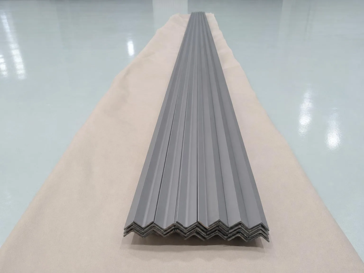 Illustration of nested gray angle profiles with repeated V-shaped bends