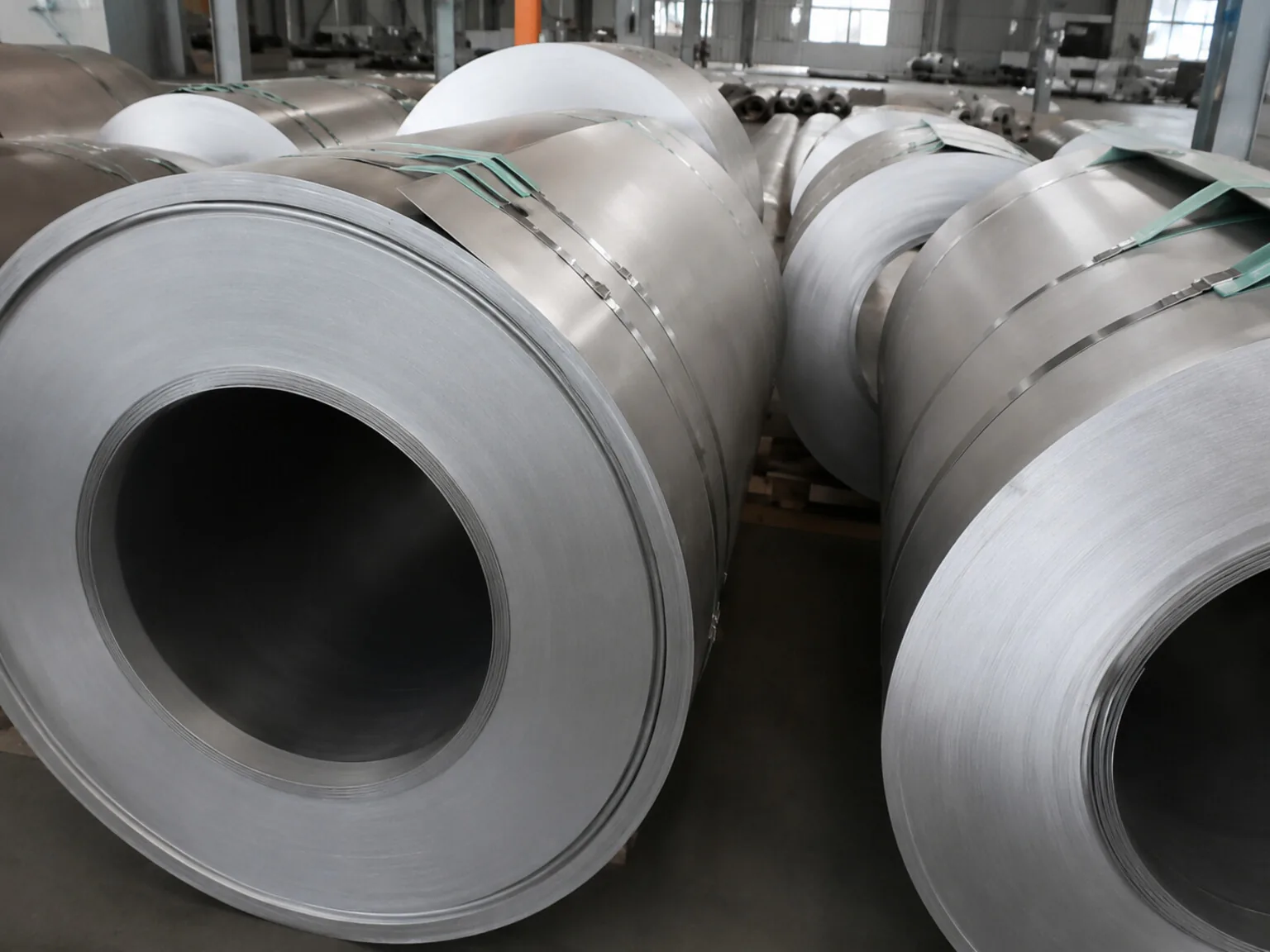 User-supplied titanium coil and shell stock illustrates the material handoff into fabricated parts where wire geometry and process environment must be controlled.