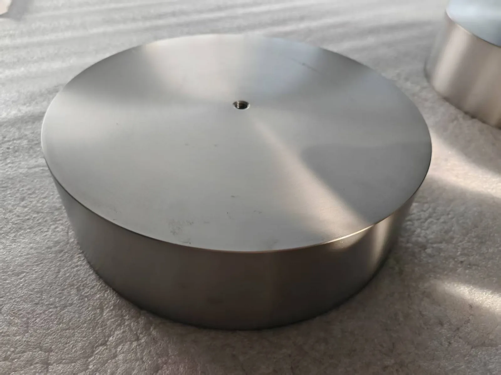 A user-supplied precision-machined titanium component illustrates why surface preparation cannot be separated from fit and connection geometry; it is not a study Ti-base.