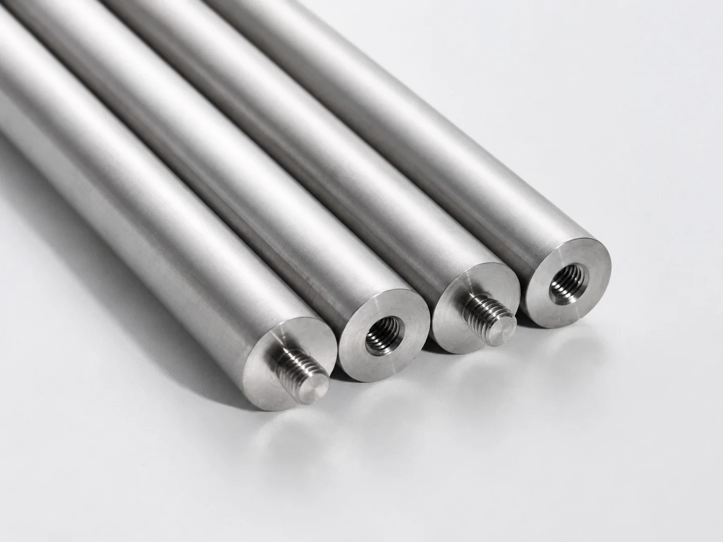 Four metal rods with external and internal threaded ends