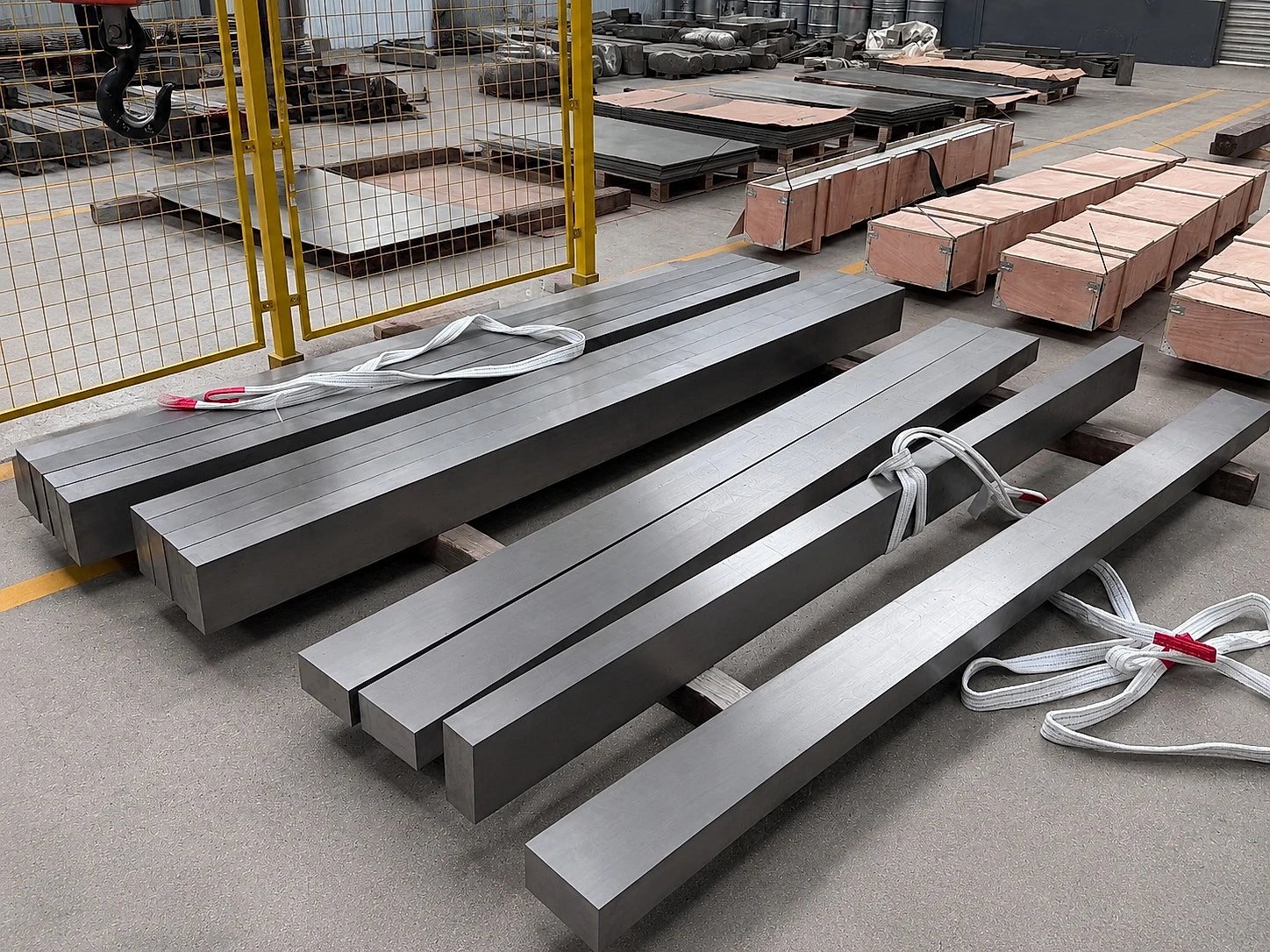 Rectangular titanium-like bars staged for handling, showing the product-form boundary that must stay linked to heat-treatment records.