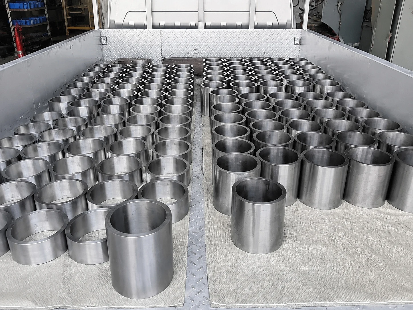 Rows of machined titanium sleeves prepared as a batch, illustrating lot consistency and release evidence for function-critical titanium components