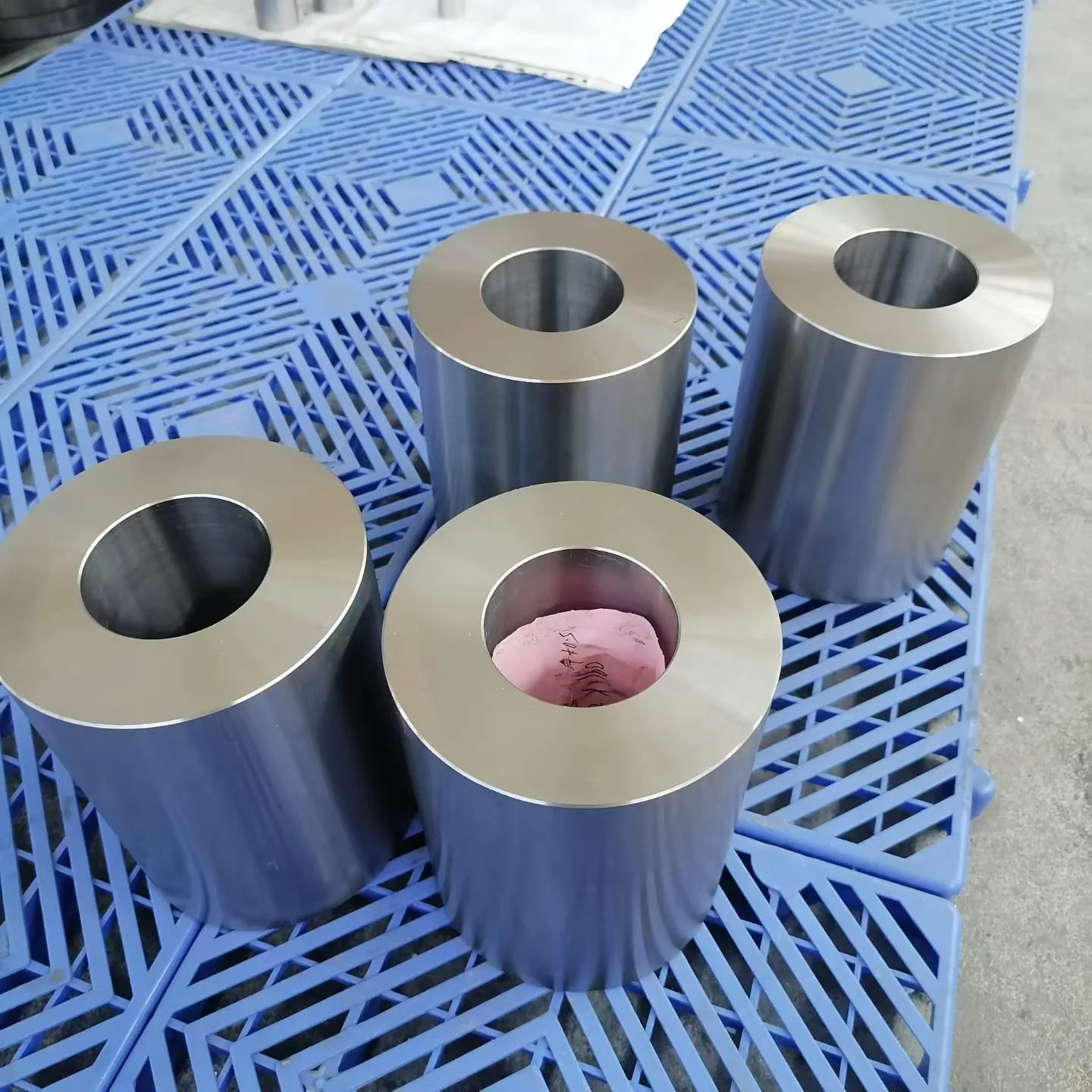 User-supplied machined titanium cylinders contrast product forms, illustrating why evidence for one geometry and use cannot be transferred by material name alone.