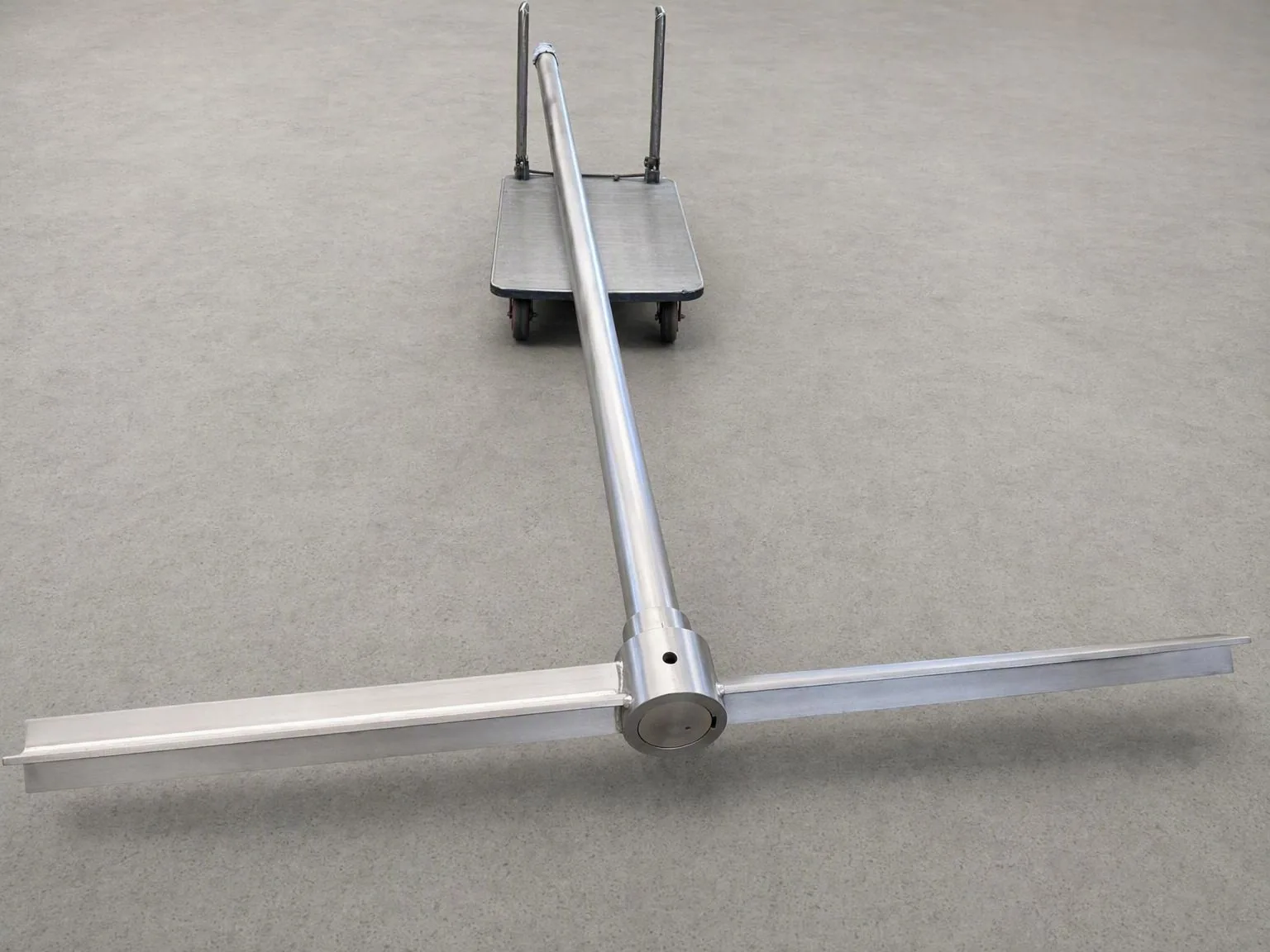 A user-supplied titanium agitator shaft illustrates a finished component whose metallic appearance cannot prove the depth or condition of an oxygen-hardened case.
