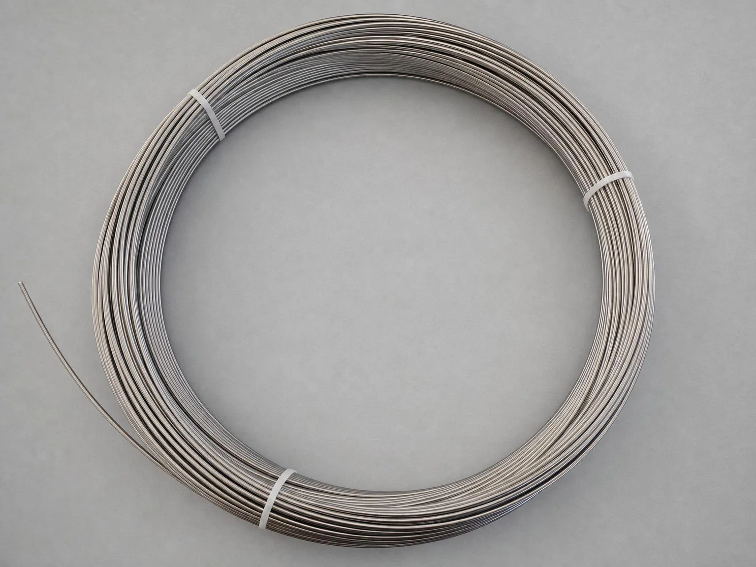 A user-supplied titanium wire coil illustrates continuous product for which surface condition, batch traceability and case evidence must be released together.