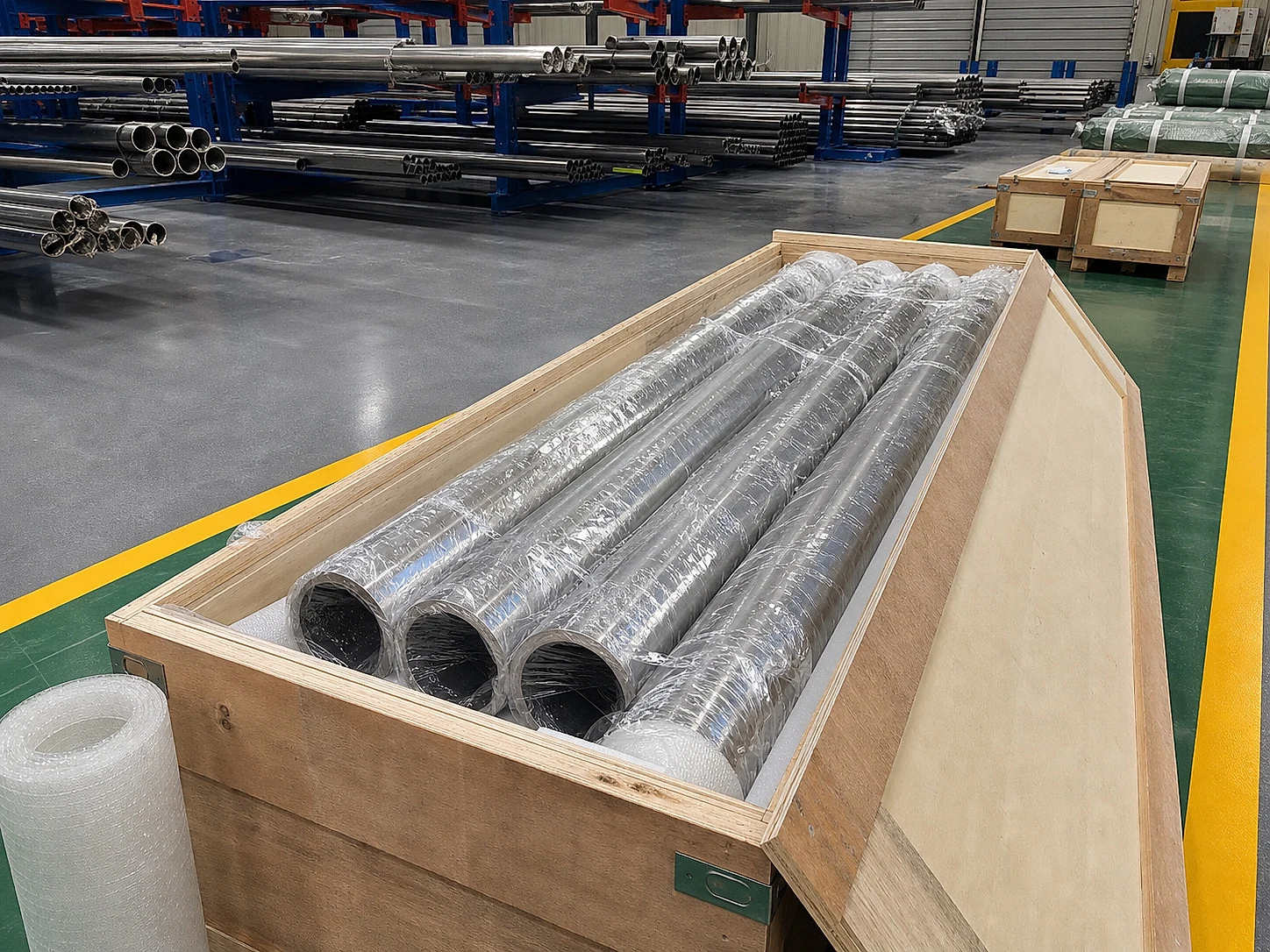 Titanium tubes packed in a wooden crate for export, connecting product release to packaging, documentation, and shipment-condition evidence after material selection