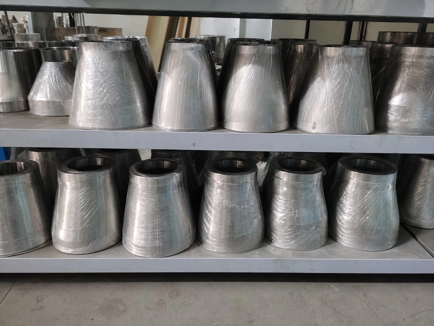 Titanium concentric reducers on storage racks